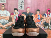 Front view of rose-gold and black Nike sneakers with black laces, black uppers, and light outsoles.