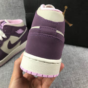 Close view of the purple heel panel, white midsole, and pink outsole.