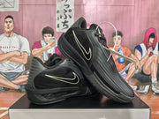 Angled view of black Nike basketball sneakers showing the light-colored Swoosh outline and ZoomX midsole branding.