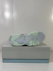 Bottom view showing the pale icy-blue outsole, circular traction details and Jordan logo.