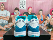Rear view of the sneakers showing the date 6.26.96 on both heels, the embossed number 24, and translucent blue heel panels.