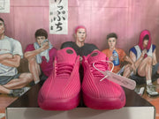 Front view of the pink basketball shoes with ribbed uppers and matching laces.
