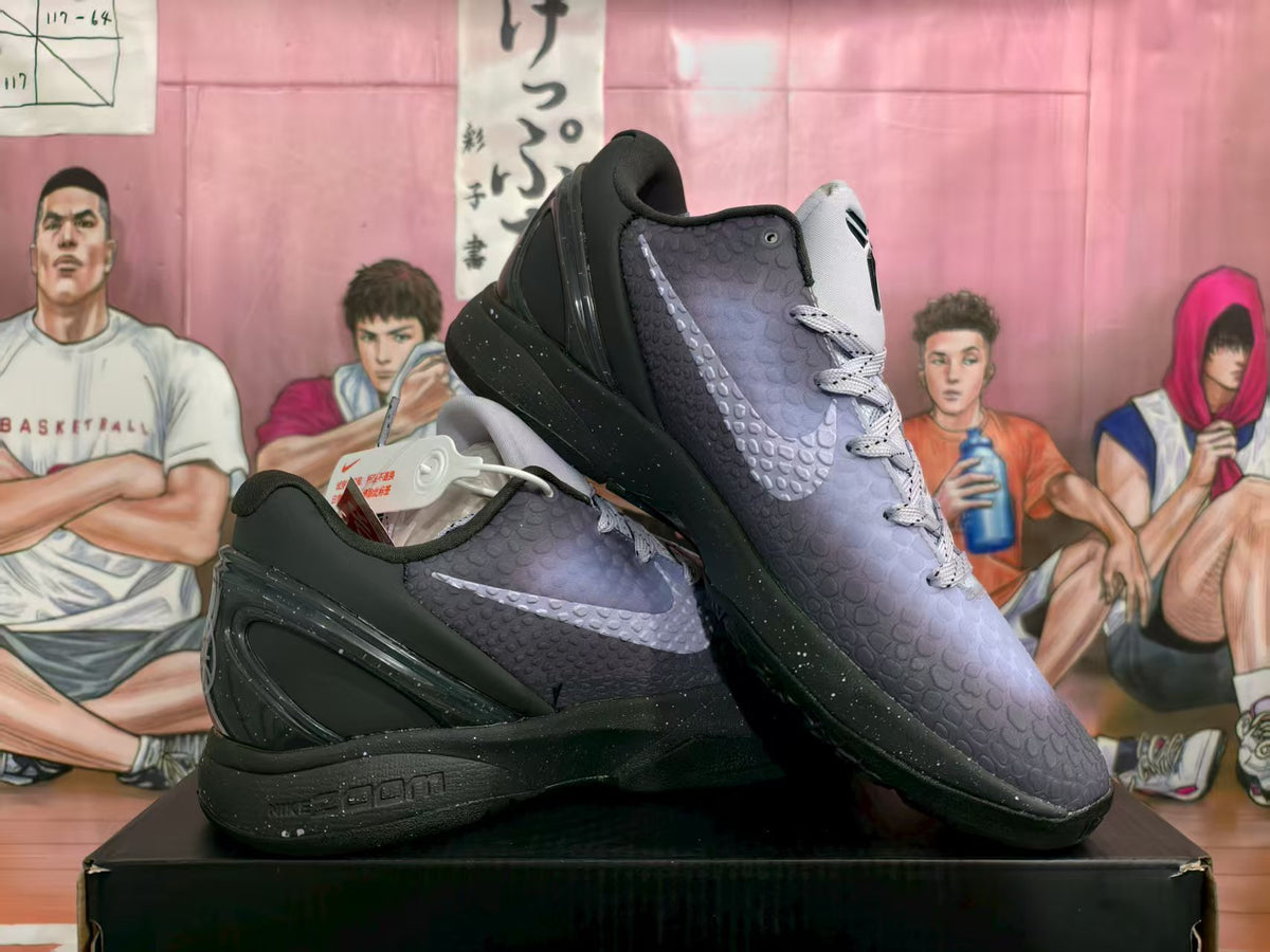 Pair of black and purple Nike basketball sneakers displayed on a box, showing textured uppers, light laces, black soles, and side swooshes.