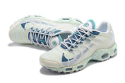 Top view of the white and teal Nike Air Max Tn sneakers, showing the laces and patterned uppers.