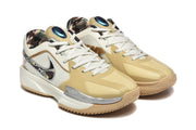 Three-quarter front view of the khaki and white Nike basketball sneakers with white laces, patterned collar lining, and layered toe panels.