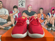 Front view showing the red uppers, red laces, gold tongue details, and white soles.