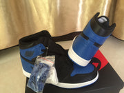 Black and royal blue high-top sneakers displayed on a Nike shoebox with extra laces in a clear bag.