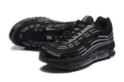 Pair of black sneakers shown from front and top angles, with gray accents and textured soles.