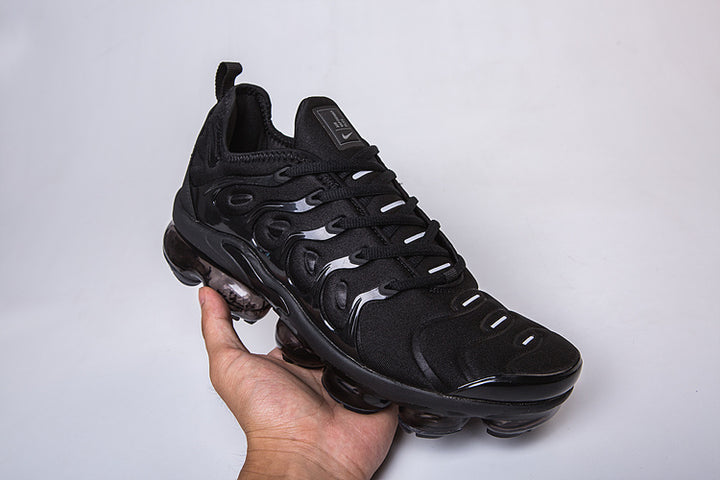 Single black Nike-style Air VaporMax Plus sneaker shown from a three-quarter angle.