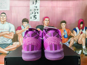 Rear view highlighting the patterned heel panels on the purple Nike sneakers.