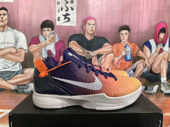 Side view of Nike basketball sneakers with a purple-to-orange gradient upper, white Swoosh, dark laces, and white midsole.