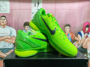 Angled product view showing both green sneakers, textured uppers, black side branding, and molded heel construction.