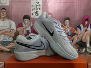 Angled view of two light blue and white Nike basketball sneakers showing the perforated upper, black Swoosh, and patterned outsole.