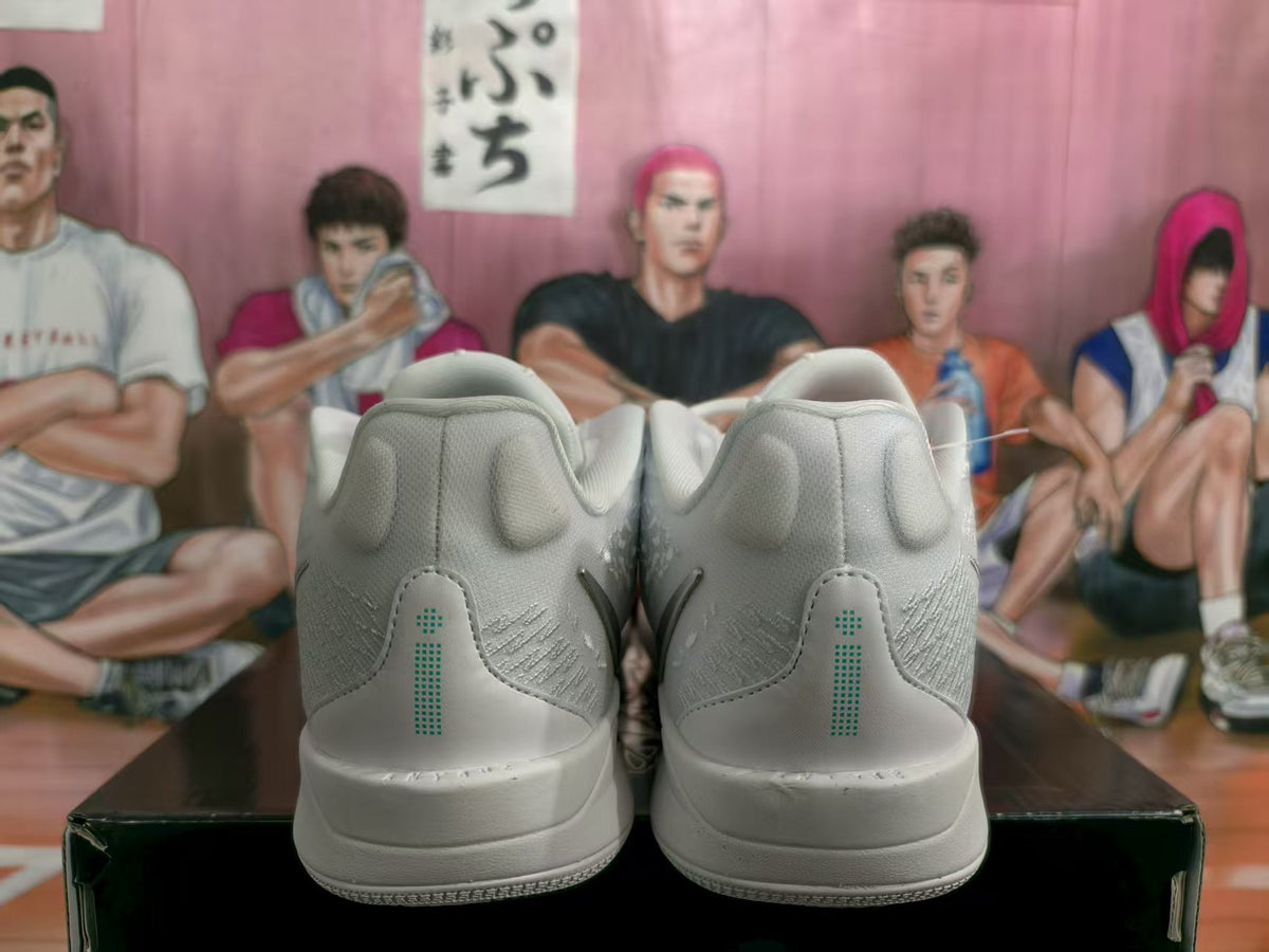 Rear view of silver and white Nike basketball sneakers showing padded collars and heel detailing.