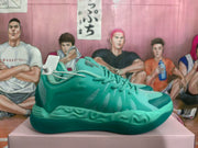 Side view of a green basketball-style sneaker showing tonal laces, textured side panels, molded midsole details, and a patterned outsole.